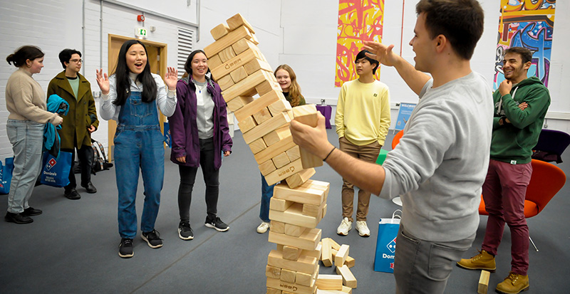 A giant jenga tower in the Games Hub, tumbling to the ground.