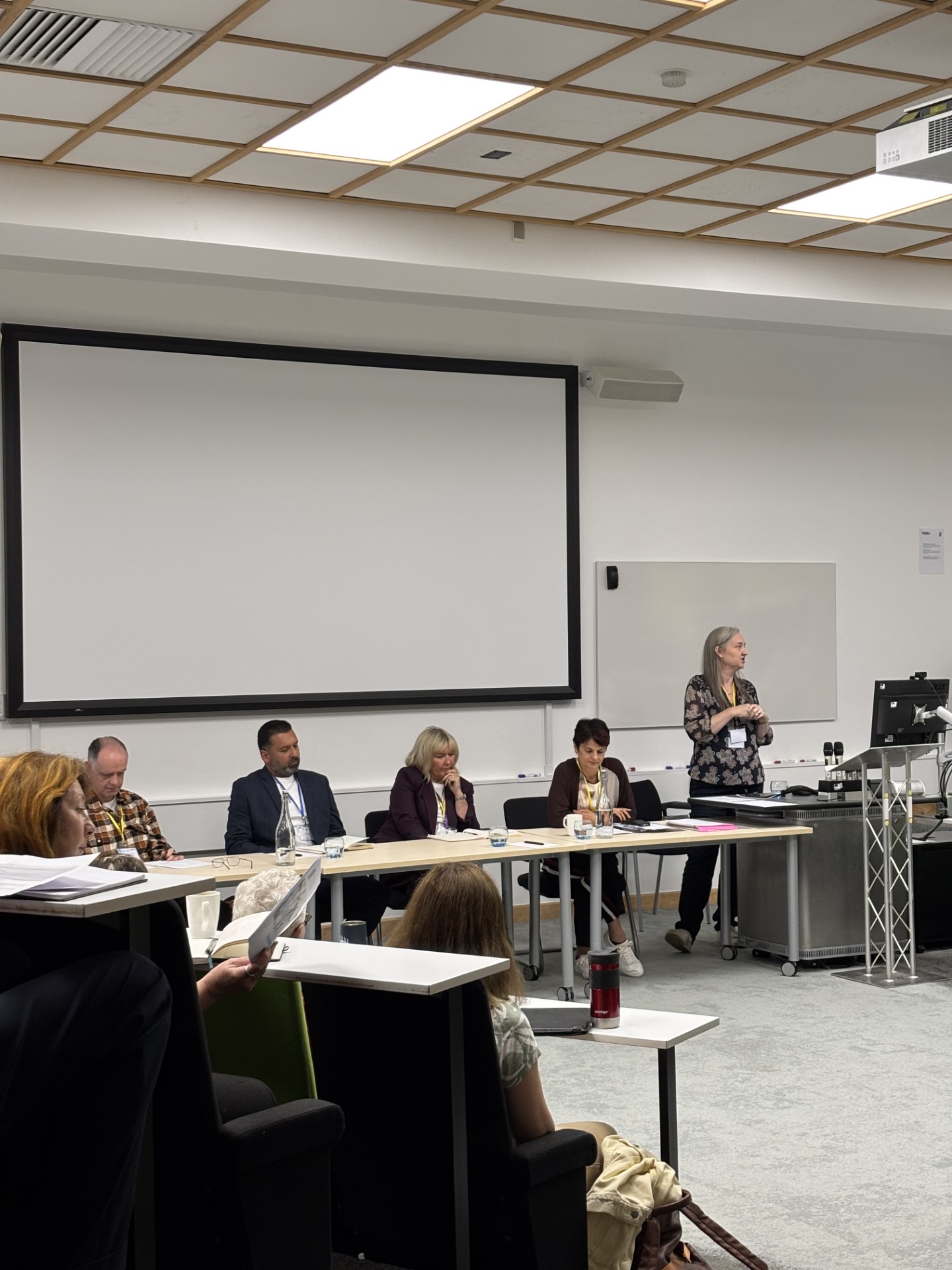 Conference panel with speakers in a row in front of the audience