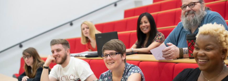 picture of students sitting in the lecture theatre smiling