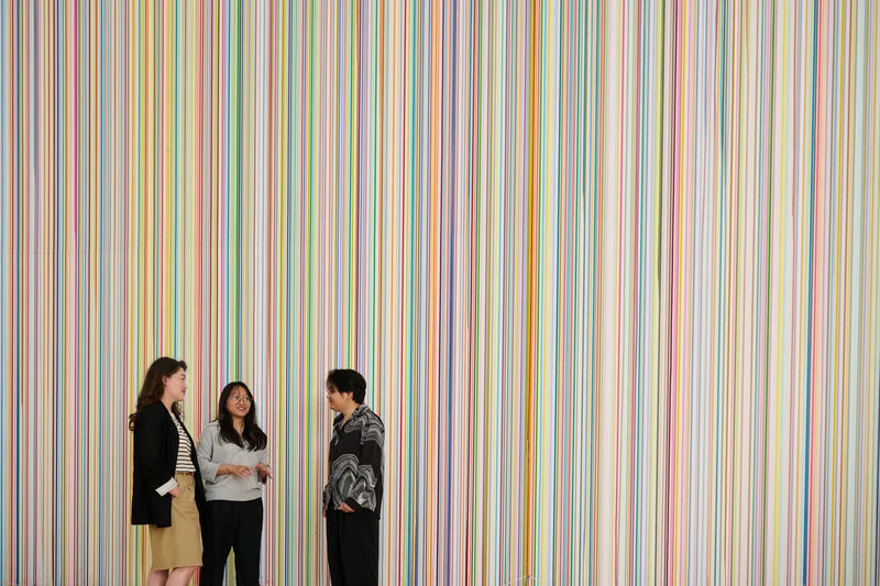 Three students having a friendly discussion indoors
