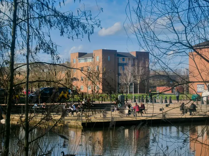 a gathering of students by the water