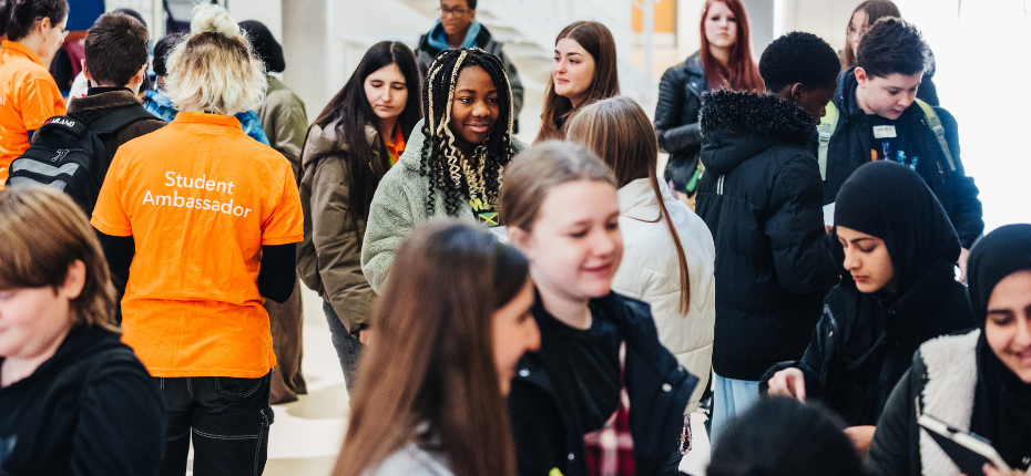 UniTracks Launch Event - students standing in the building foyer completing a bingo quiz