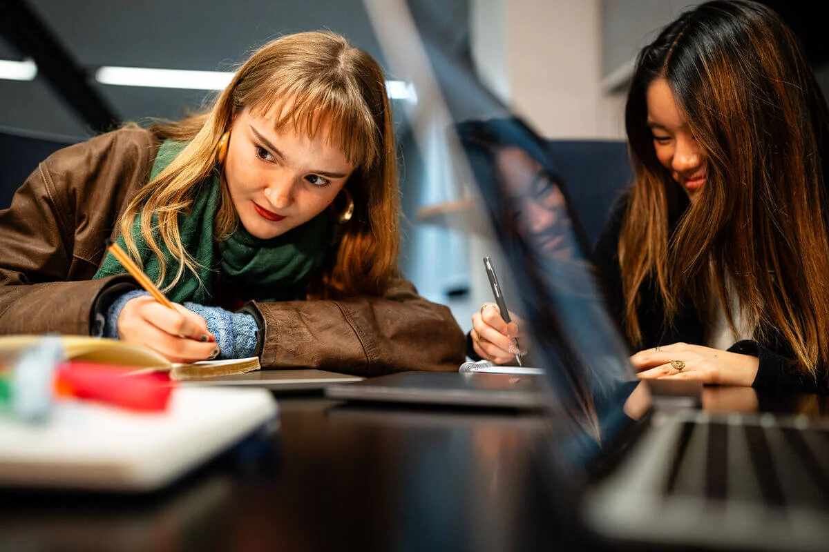 Two students working at a table
