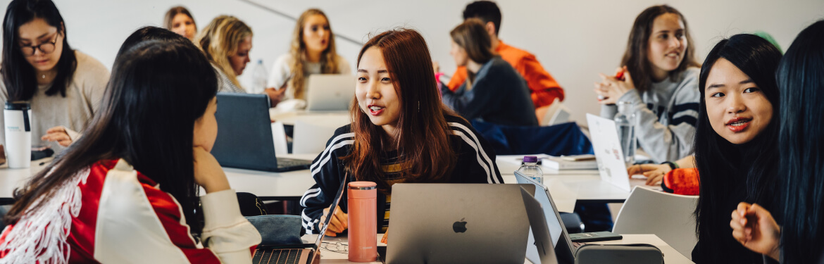 This image shows a cohort of diverse students in a TESOL classroom