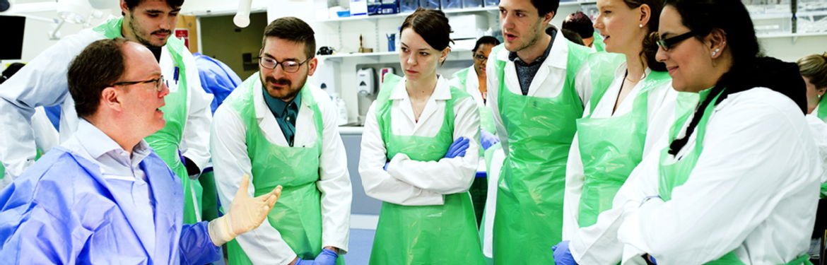 a group of warwick medical school students gather round their tutor