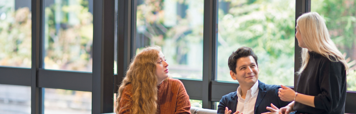 two students work together at a computer as part of their MPhil/PhD Business and Management