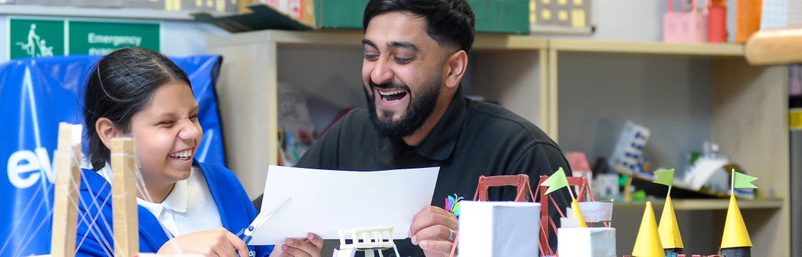 young child reading with young man