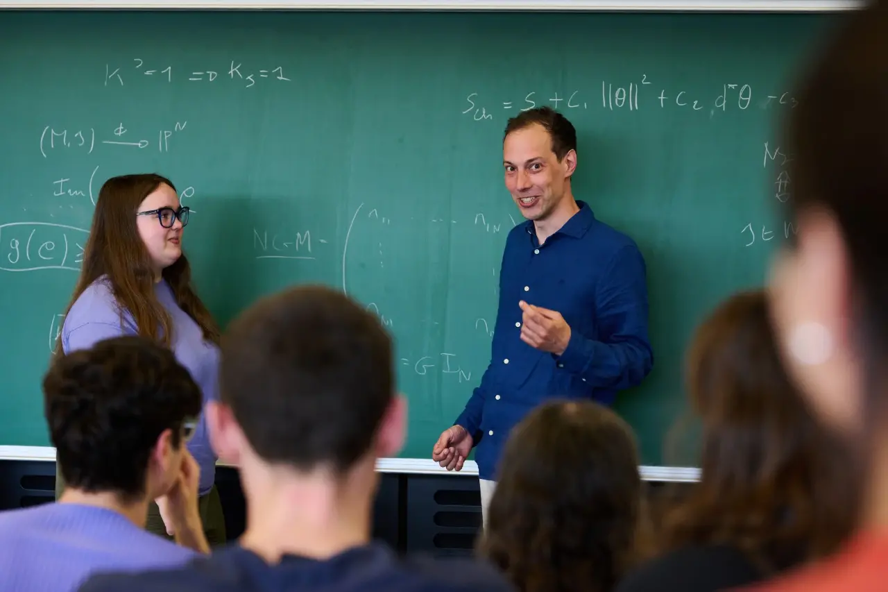 Lecturer teaching a mathematics class.