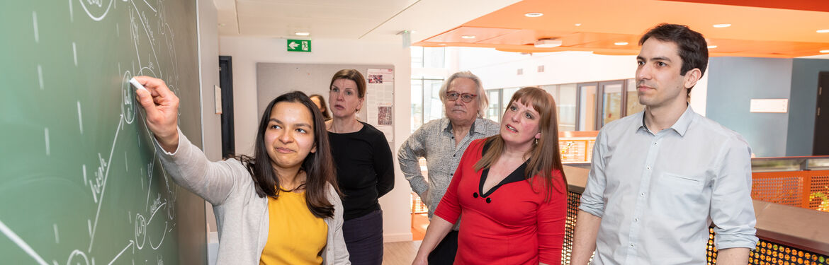 This image shows Statistics with Data Science students in front of a black board