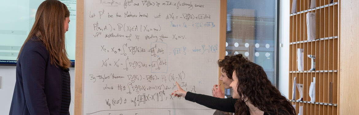 This image shows Statistics with Probability students discussing in front od a white board