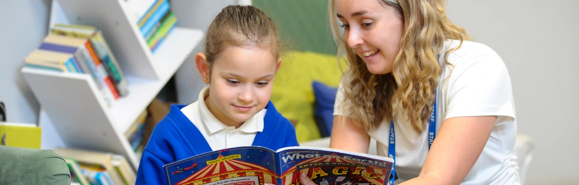A teacher reading to a young child