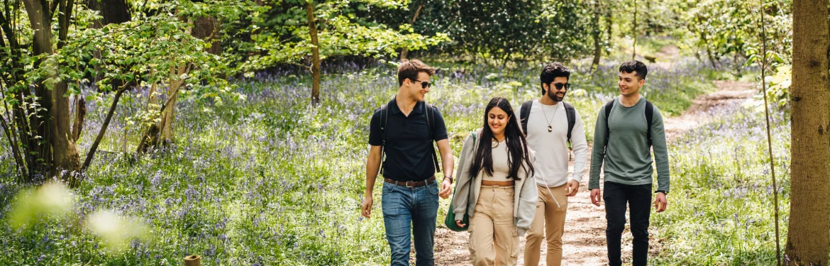 Students walking through campus discussing Translation and Transcultural studies.