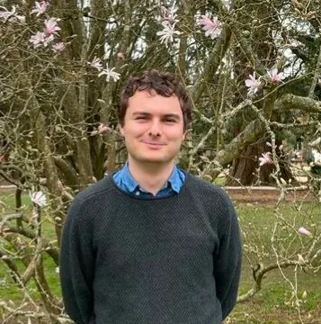 Owain Burrell smiling at camera