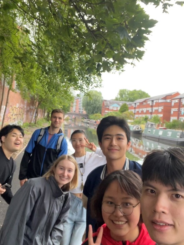 Group of students smiling with a canal in the background