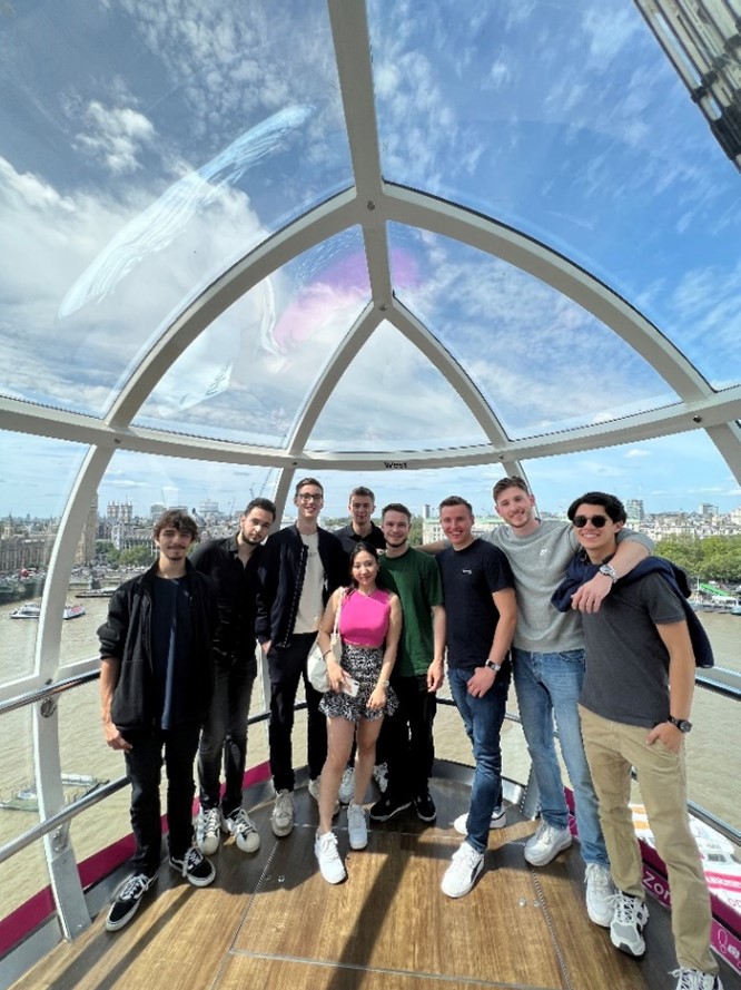 Group of students posing in the London Eye with London in the background