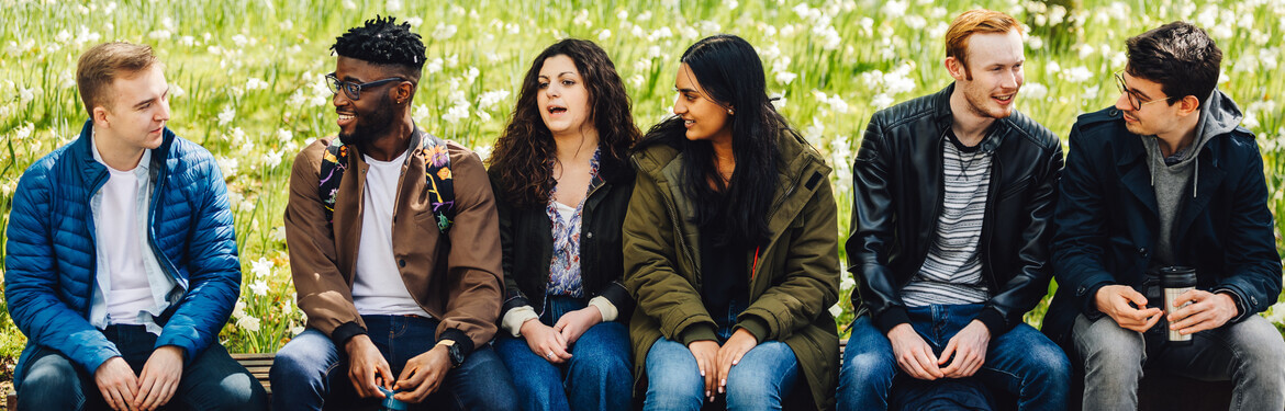 This image shows a group of students socialising outside on campus.