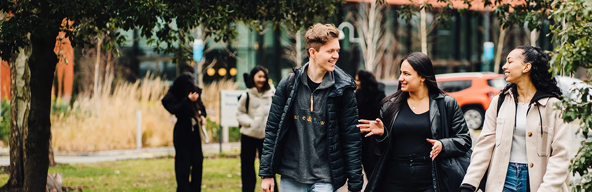 Students having a friendly discussion outside the Faculty of Arts Building on campus
