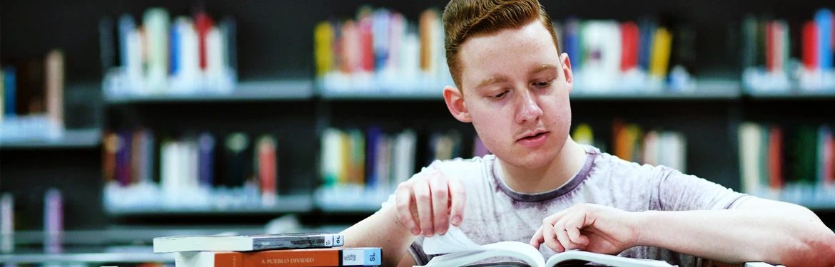 A Philosophy and Politics student reading a book in a library