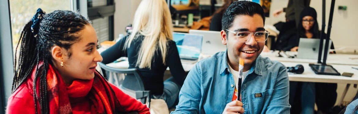 Students in a creative workshop discussing innovative ideas