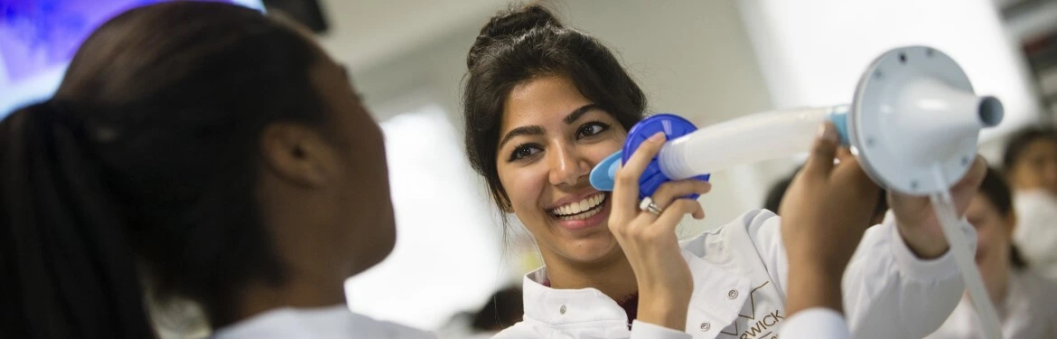 Biomedical students holding a breathing apparatus