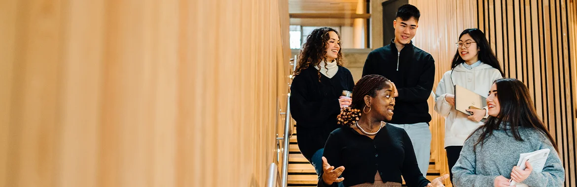 Five students having a friendly discussion