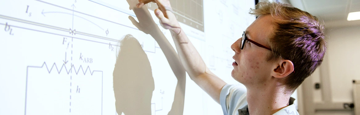 Systems Engineering student working at the whiteboard in University of Warwick