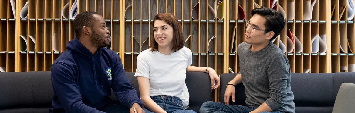 Three students having a friendly discussion