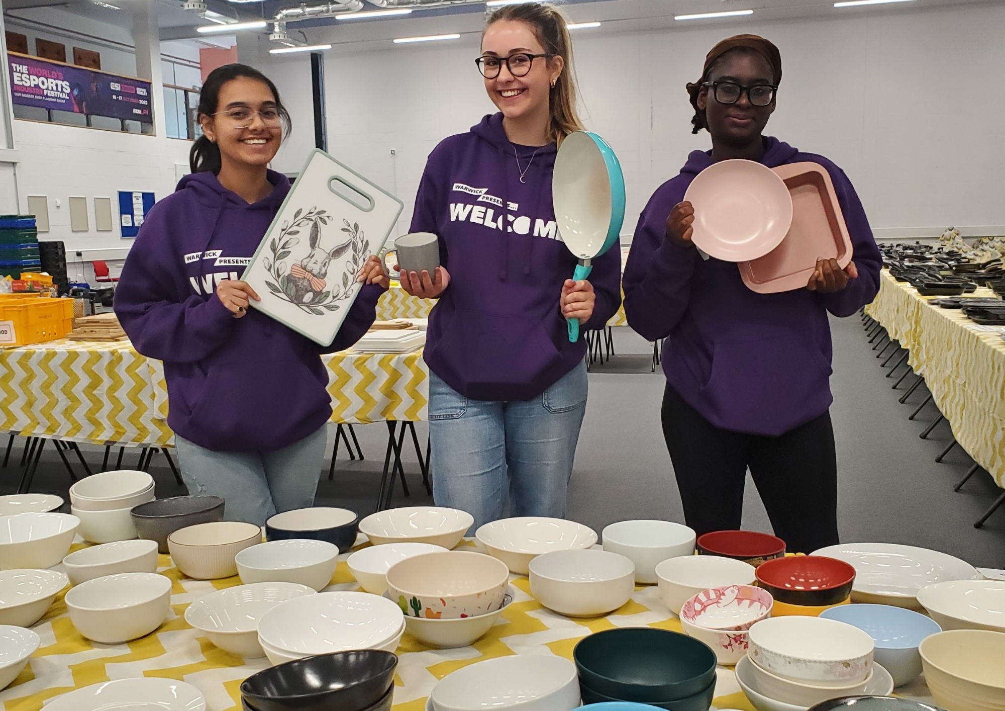Three students volunteers at the Kitchen Kit Market in 2024
