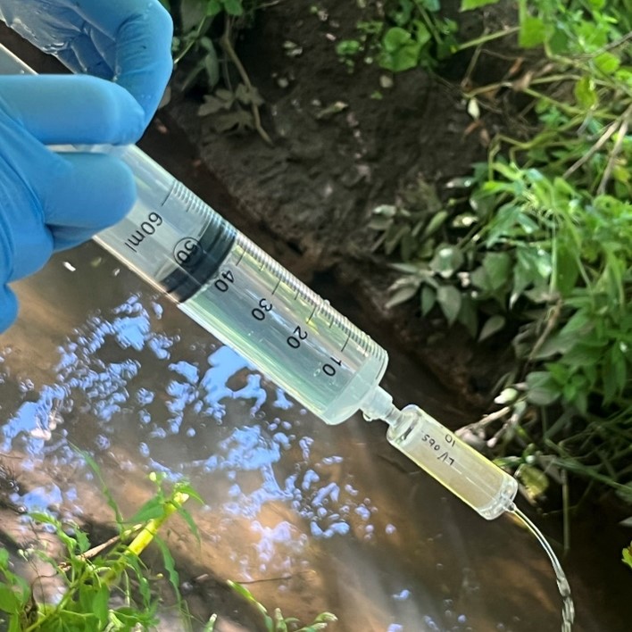 Collecting an aquatic eDNA sample by pumping water from the River Sowe through a filter at Lakeview Park, Coventry.