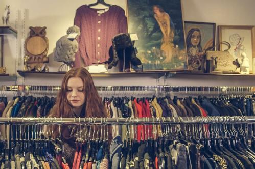 woman shopping a clothing rails