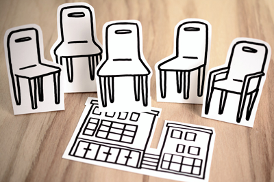 empty chairs cut out of paper