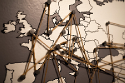 map of europe with countries connected by strings attached to pins