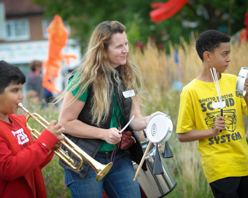 People at a community carnival playing instruments