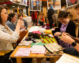 People sat round a table crafting together at an engagement event