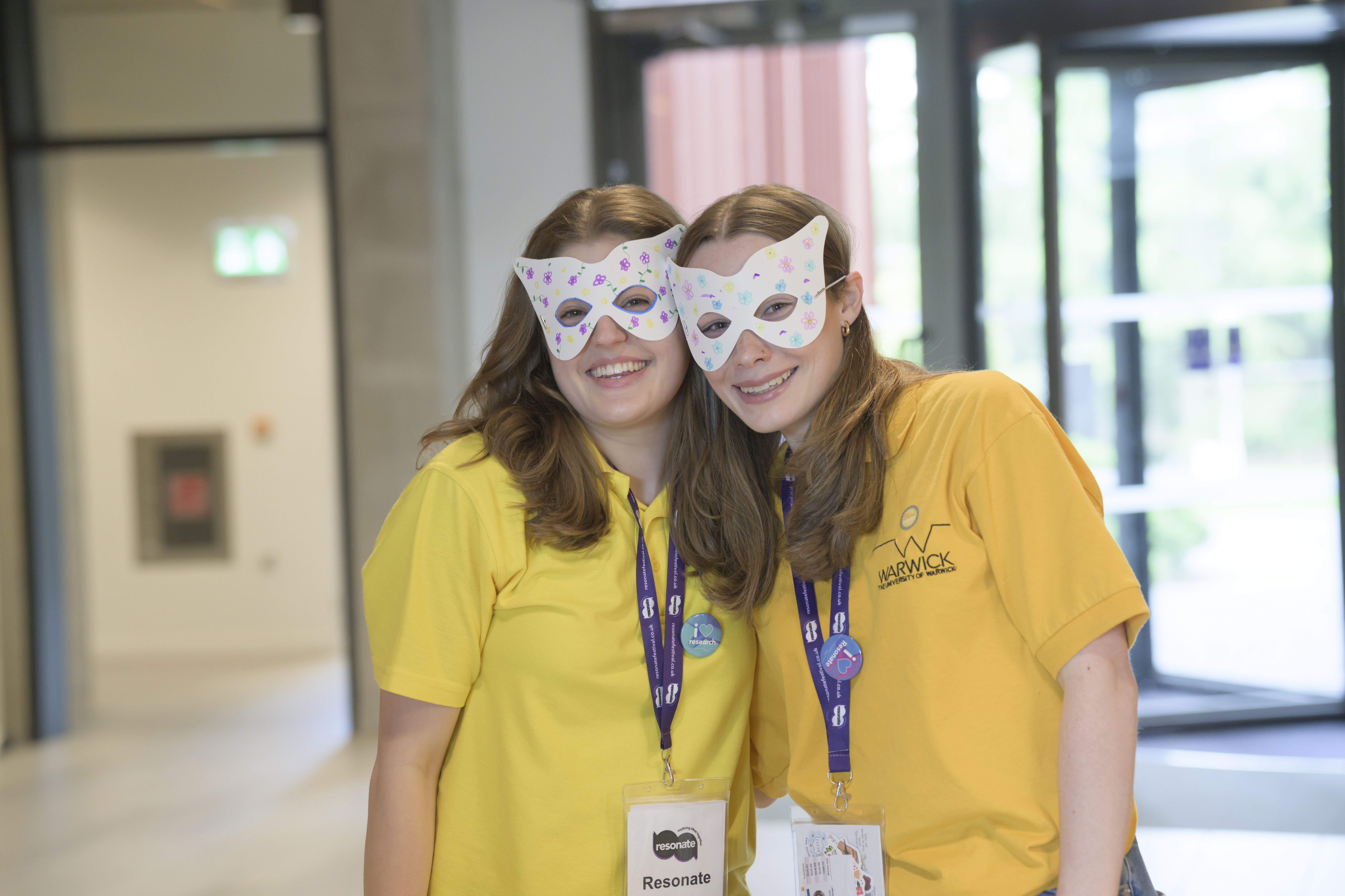 Two Warwick Welcome Service staff with handmade masks round their eyes