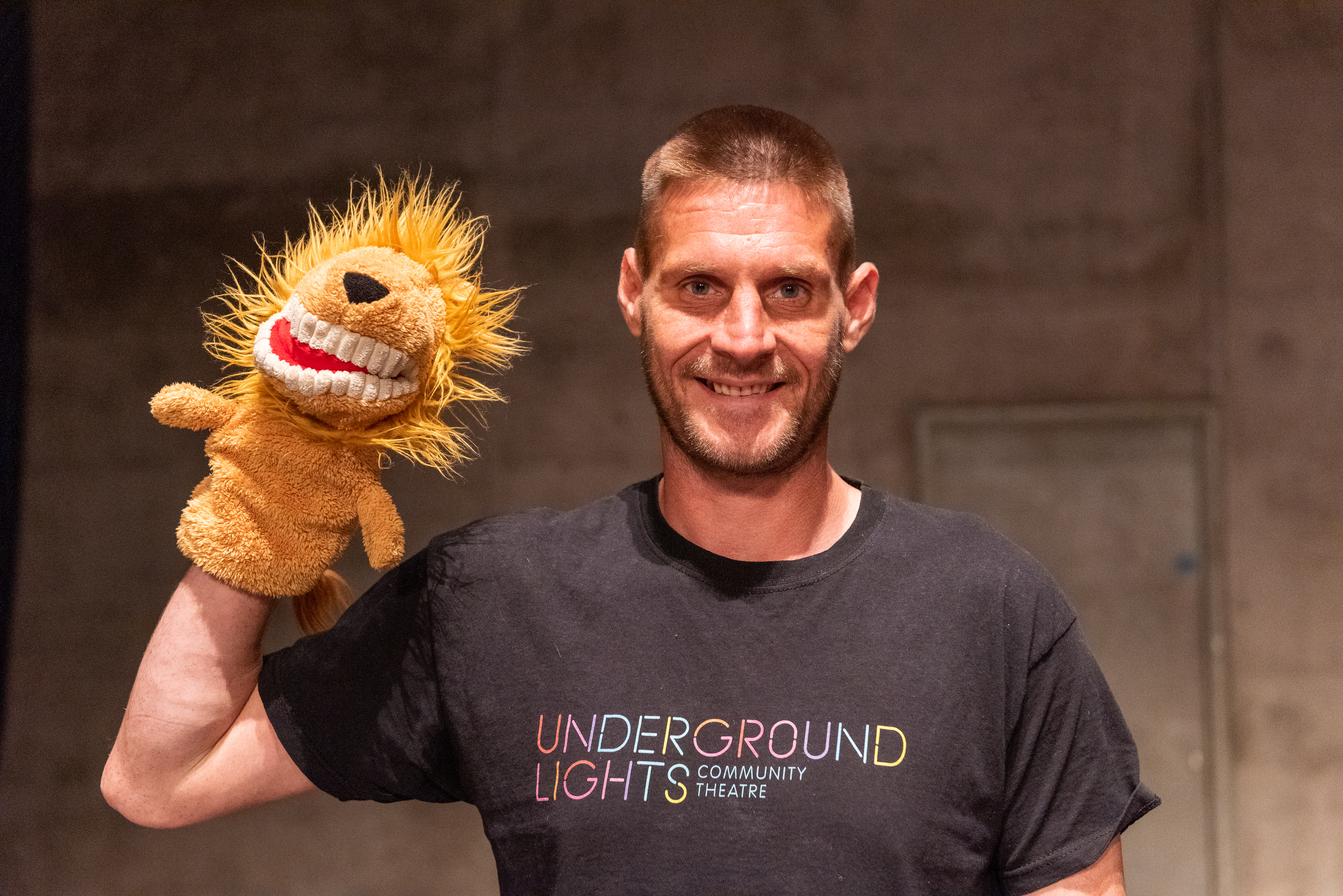 Man holding a puppet of a lion - Stuart Hollis Photography