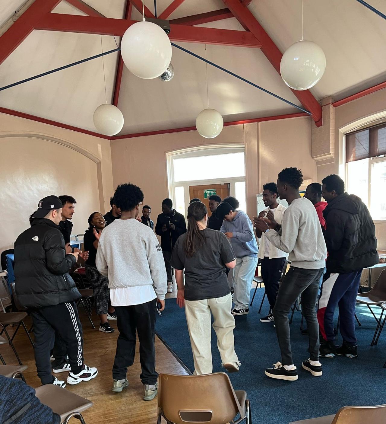 Lots of people stood around in a circle 