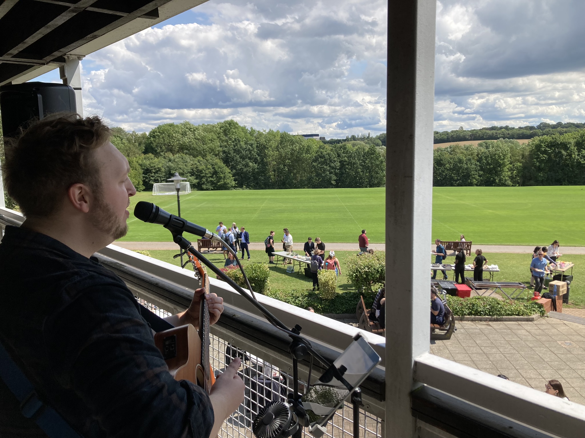Image of guitar player overlooking the Cryfield Sports Pavilion