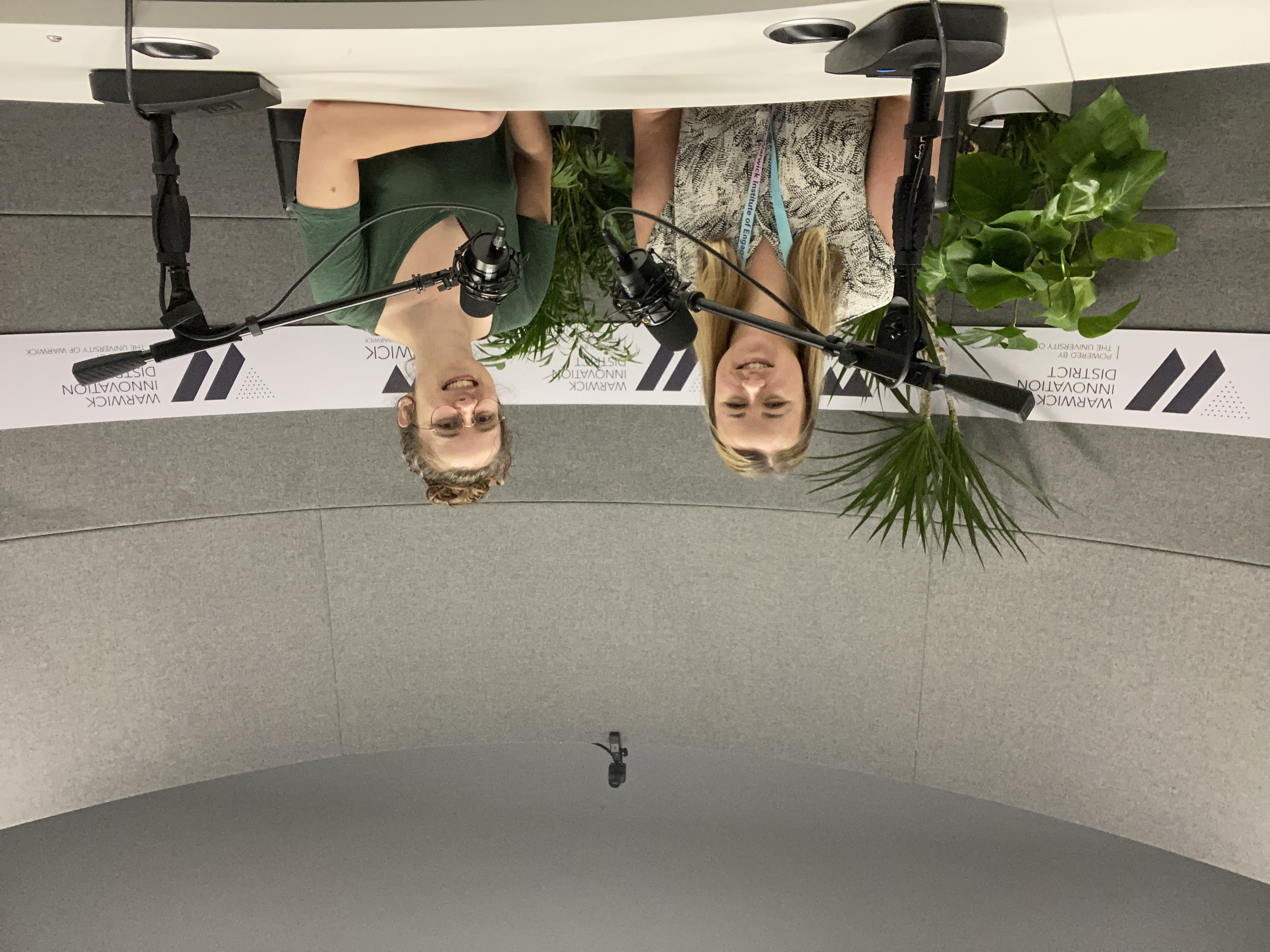 Rachel Hayes (Left) and Eleanor Harrison (Right) sitting behind a desk with microphones in front of them