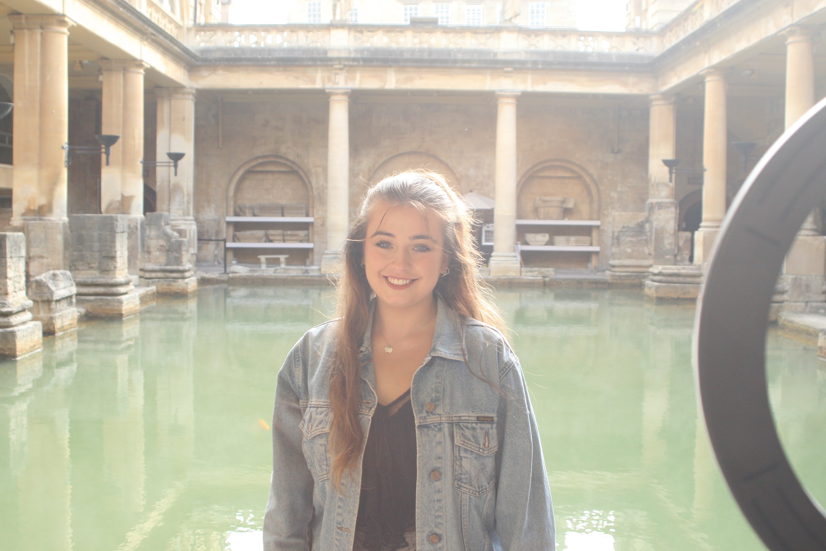Tallulah standing in front of a Roman bath
