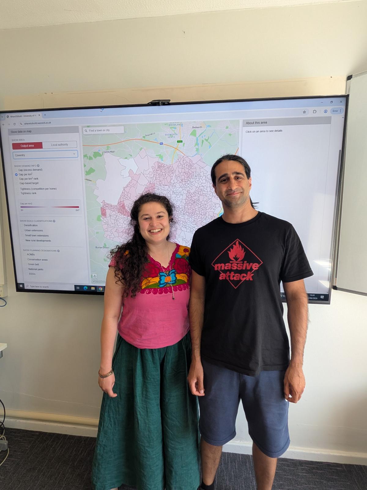 Amrita Kulka (left) and Nikhil Datta (right) stood in front of a screen