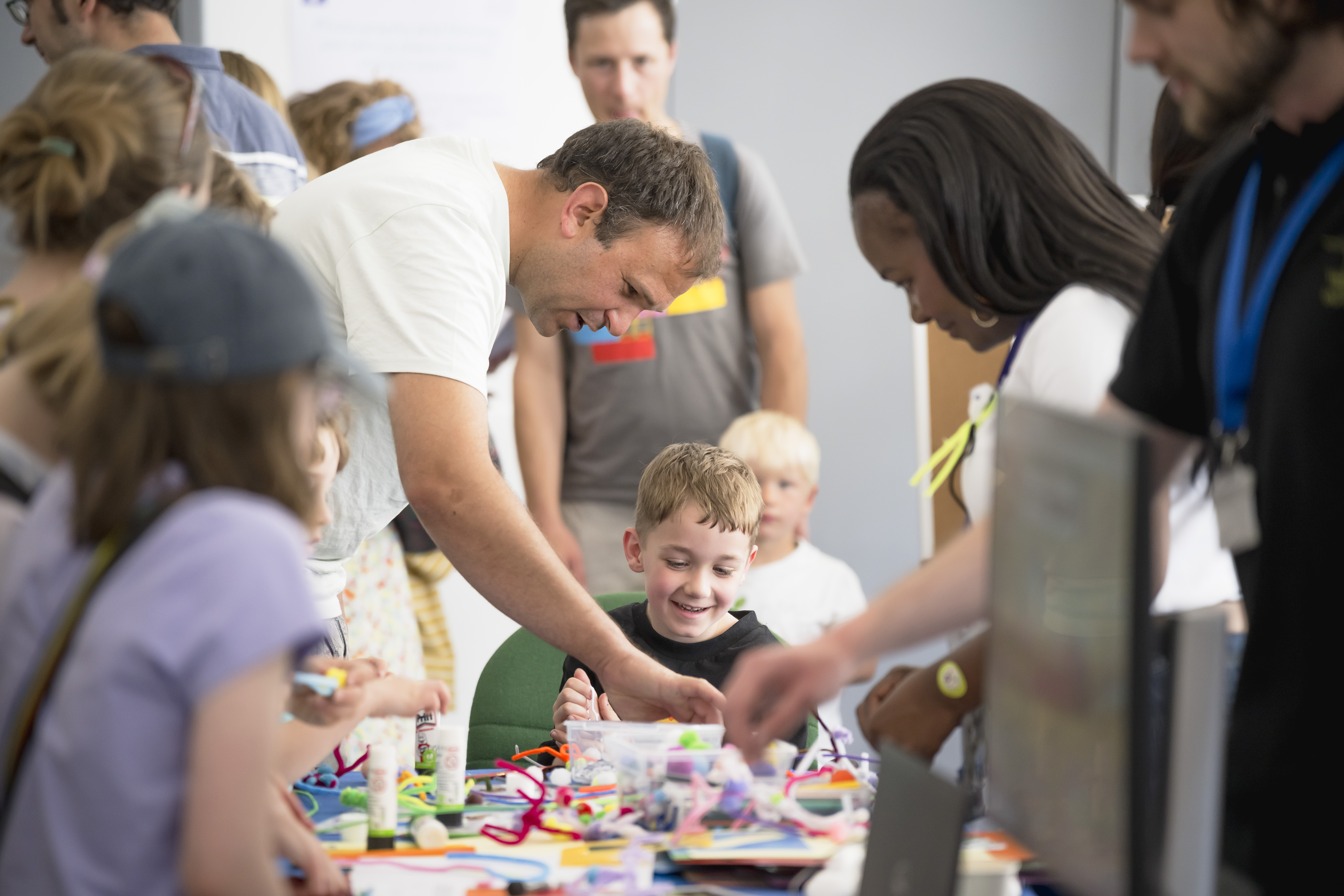 Adults and children enjoying a craft activity.