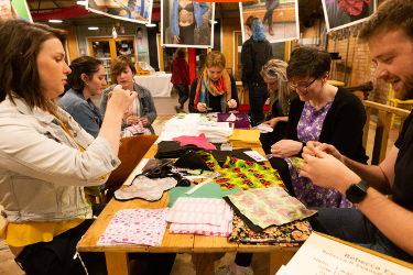 People crafting together round a table